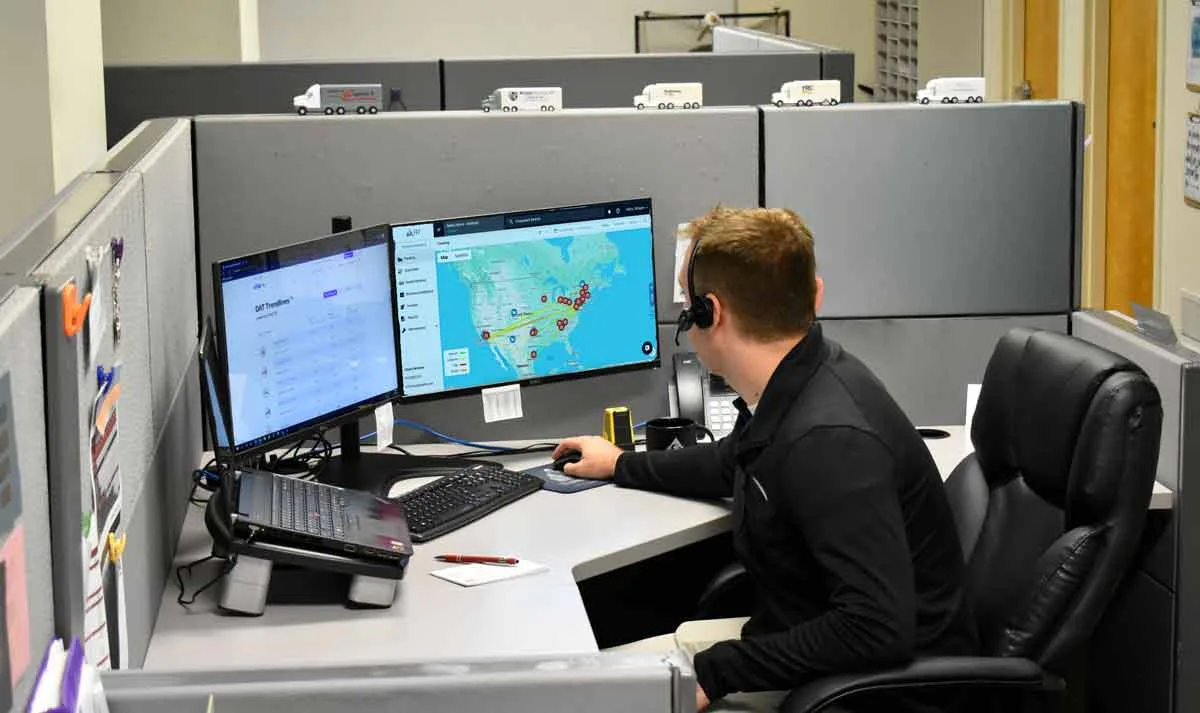 Transportation management company team using TMS software to track shipments